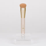 Makeup brush with a gold and beige handle on a white background