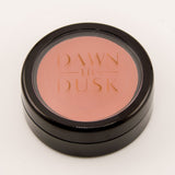Cosmetic compact with blush color on a white background
