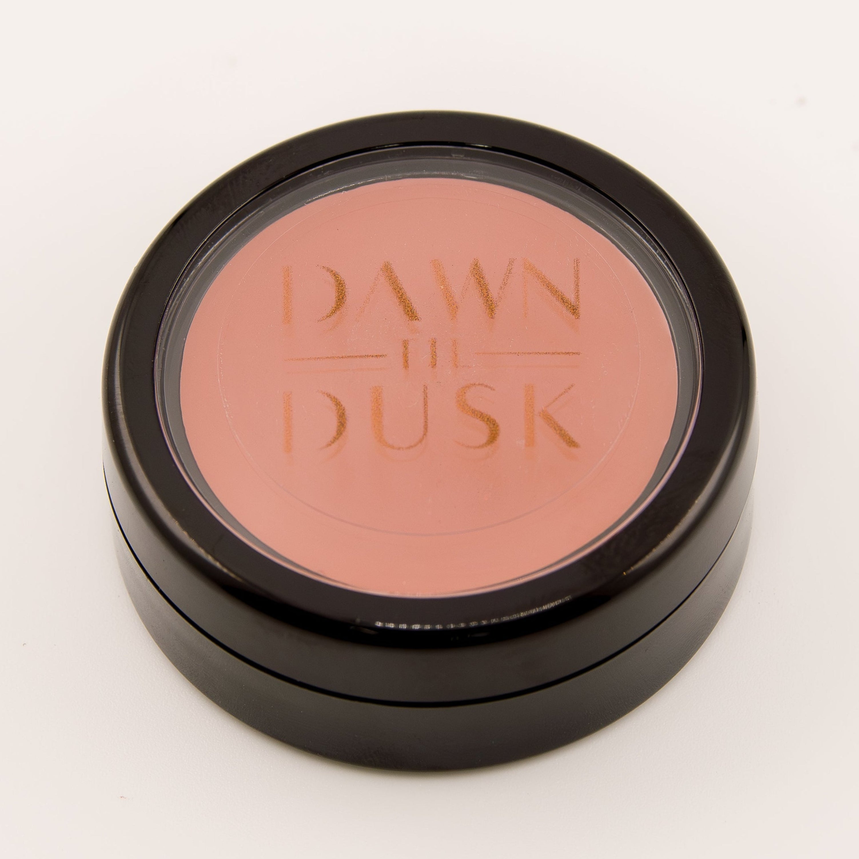 Cosmetic compact with blush color on a white background