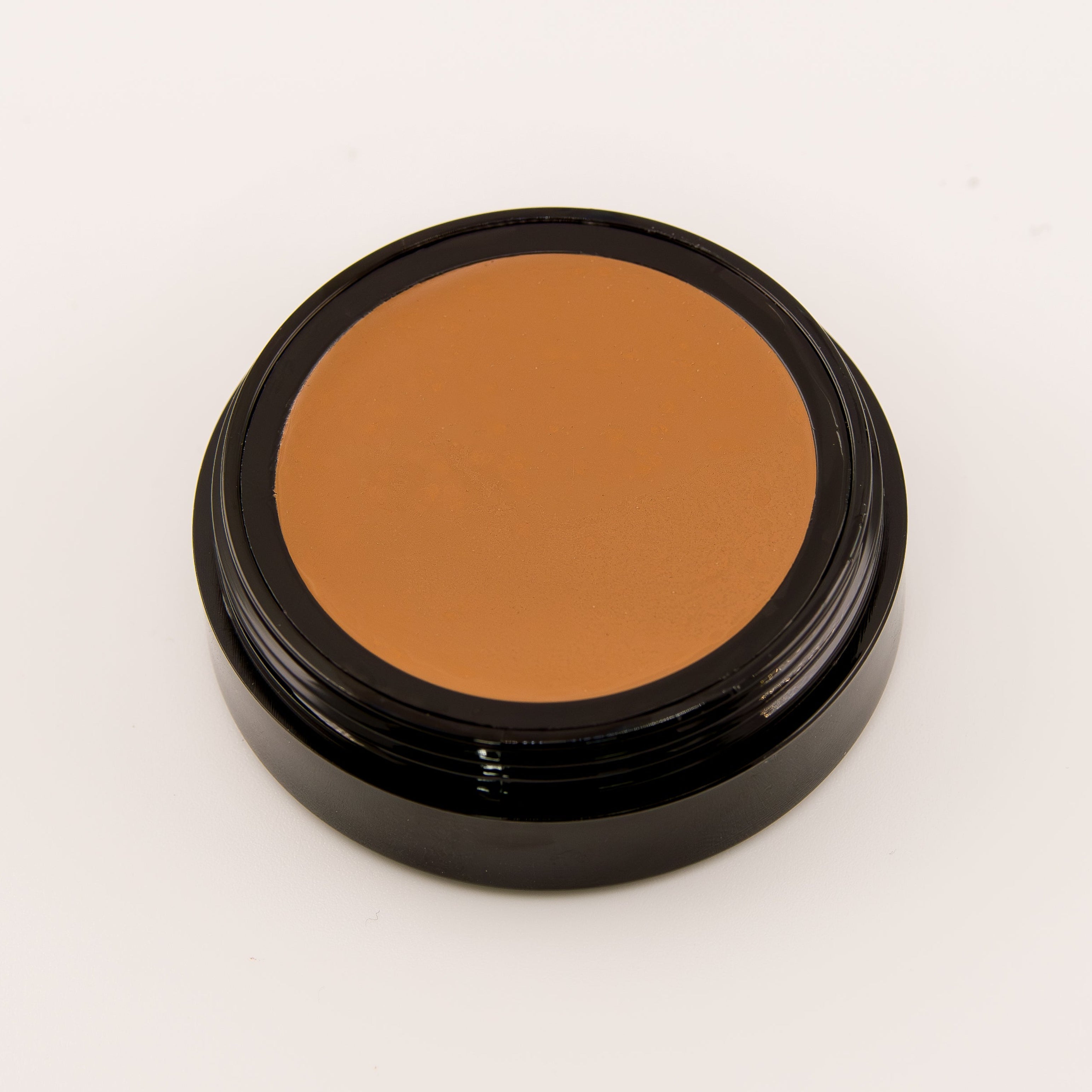 Brown makeup compact on a white background