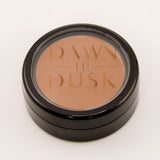 Makeup compact with 'Dawn Til Dusk' branding on a white background