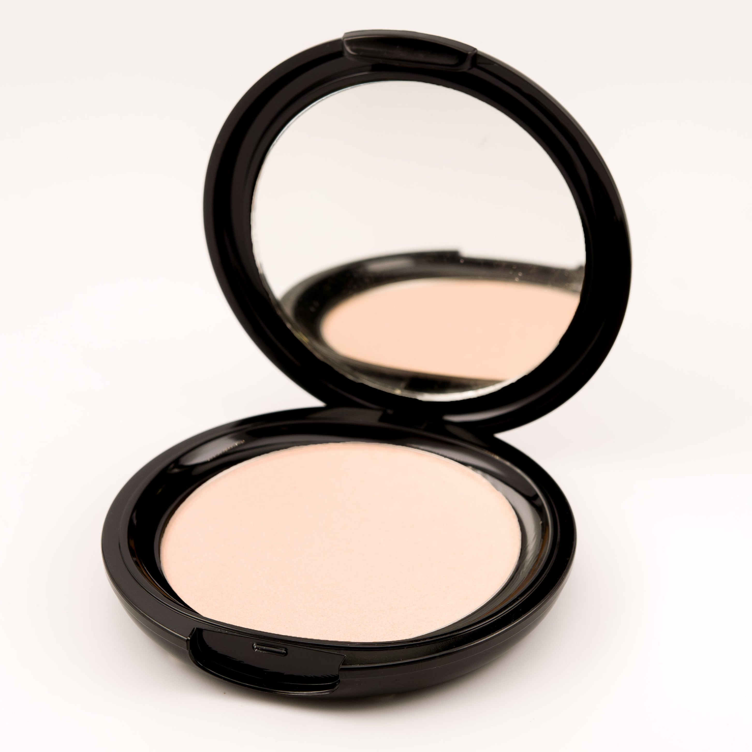 Compact powder with mirror on a white background
