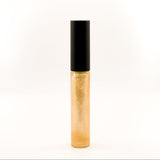 A single tube of gold glitter lip gloss or liquid lipstick with a black cap, standing upright against a plain white background.