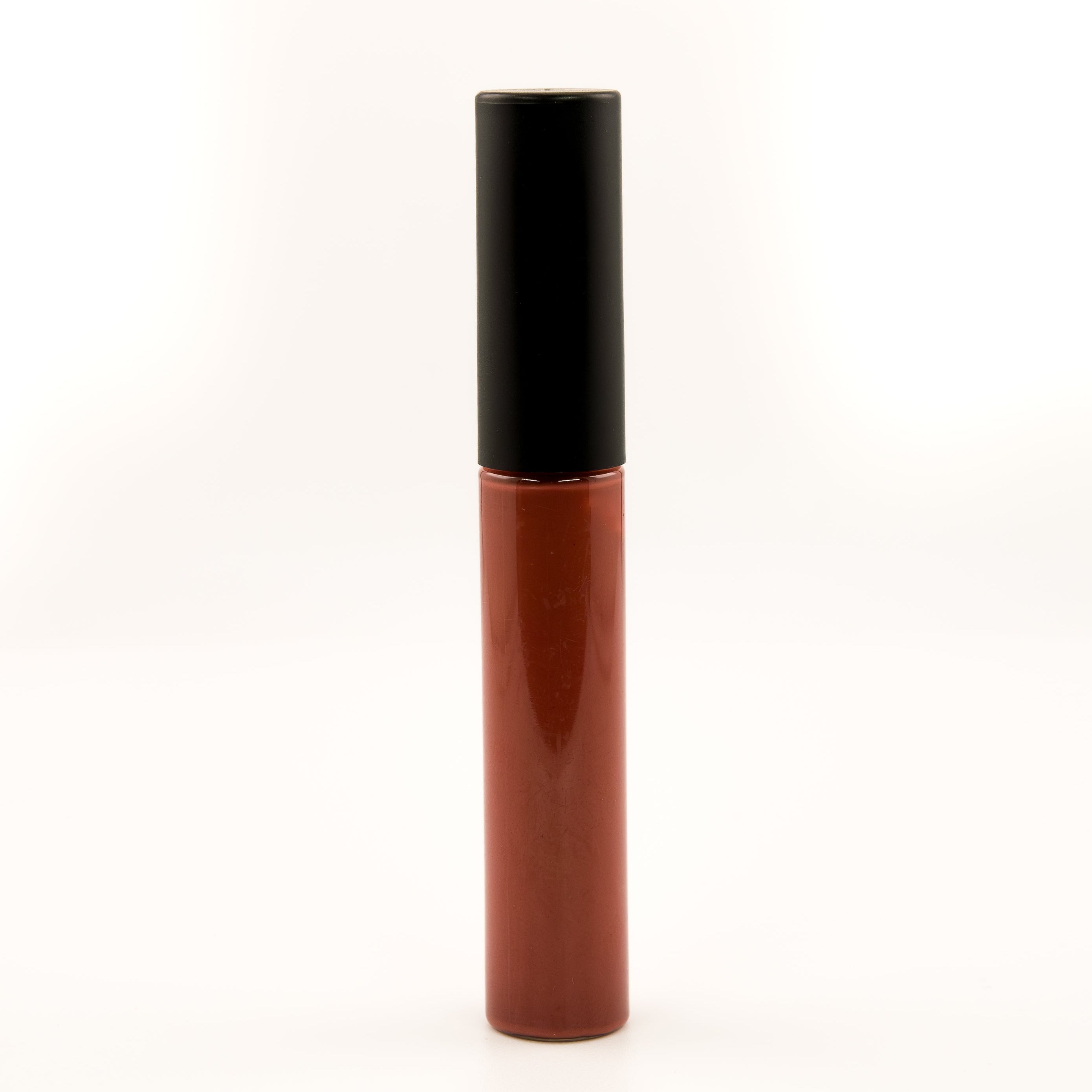 A single tube of liquid lipstick or lip gloss standing upright on a plain white background. The lower portion is a warm reddish-brown shade, and the cap is black.