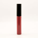 A single tube of liquid lipstick or lip gloss standing upright on a plain white background. The lower portion is a deep rosy red, and the cap is black.