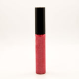A tube of glittery pink-red lip gloss or liquid lipstick with a black cap, standing upright on a plain white background.