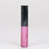 Lip gloss with pink bottom and black top on a white background