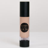 Cosmetic bottle with black cap and beige body on a white background