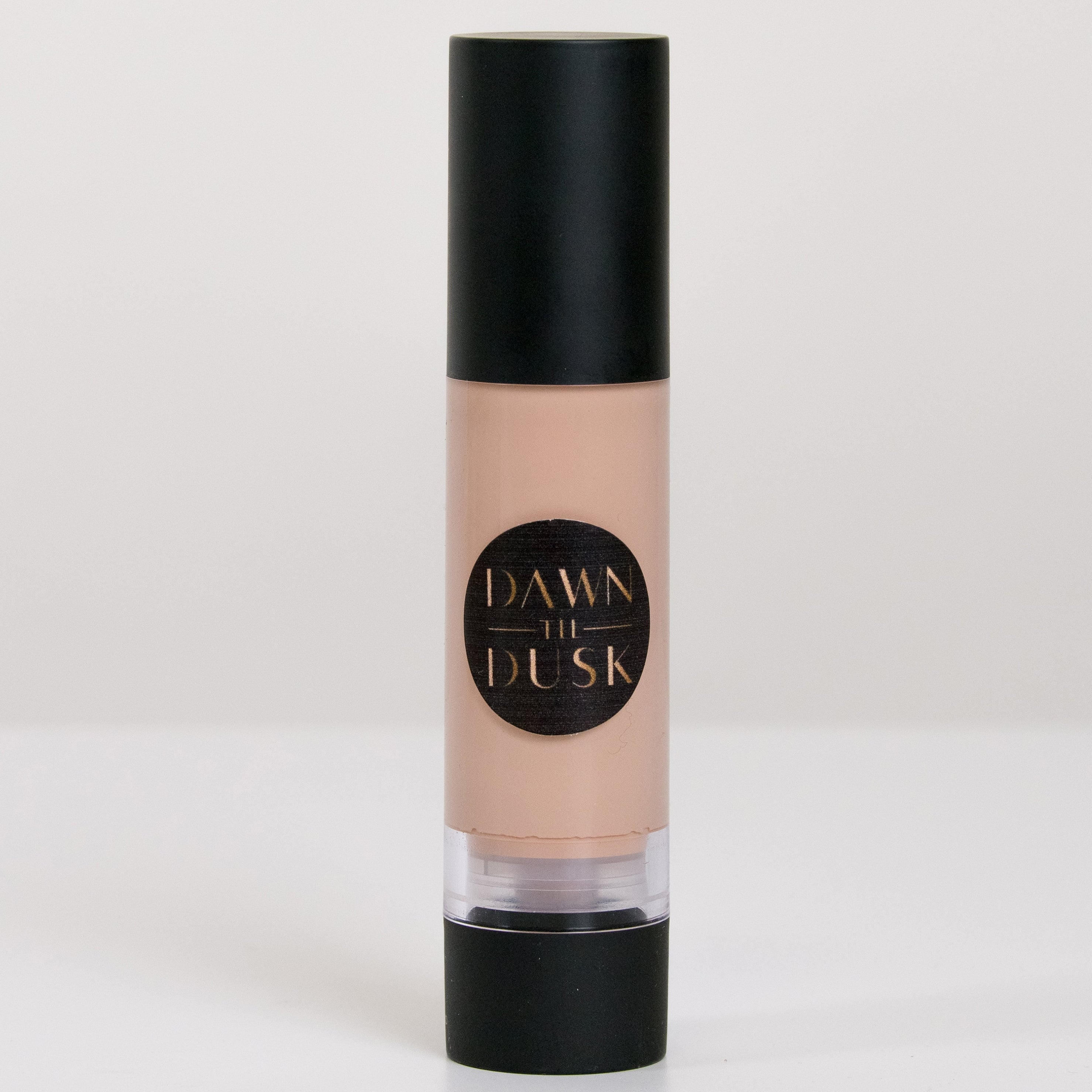 Cosmetic bottle with black cap and beige body on a white background